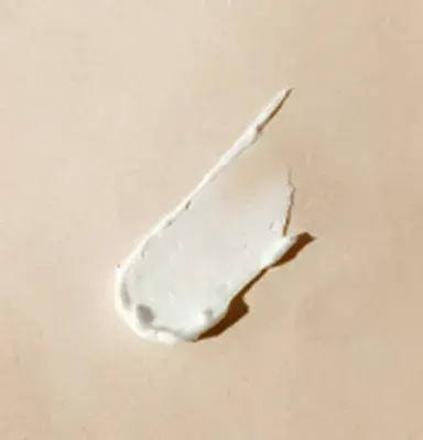 Drop of cream on white surface
